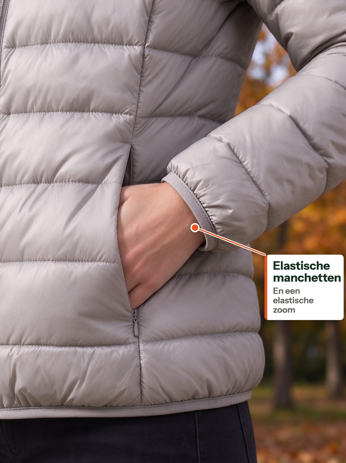 Elastic cuff of the light down jacket around the wrist, hand in the side pocket (NL label)