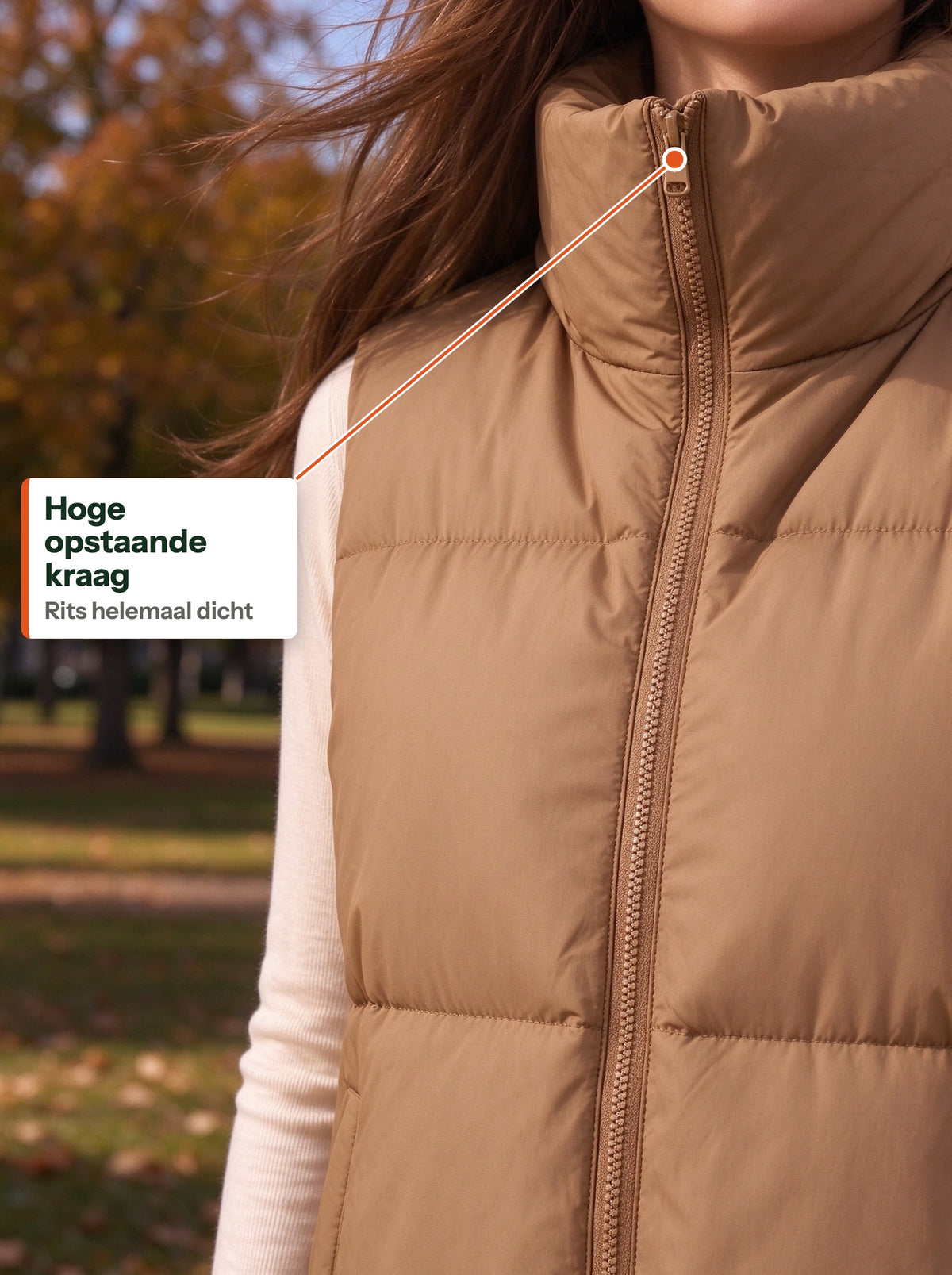 Tall stand-up collar of the camel quilted vest zipped up in a windy park (NL label)