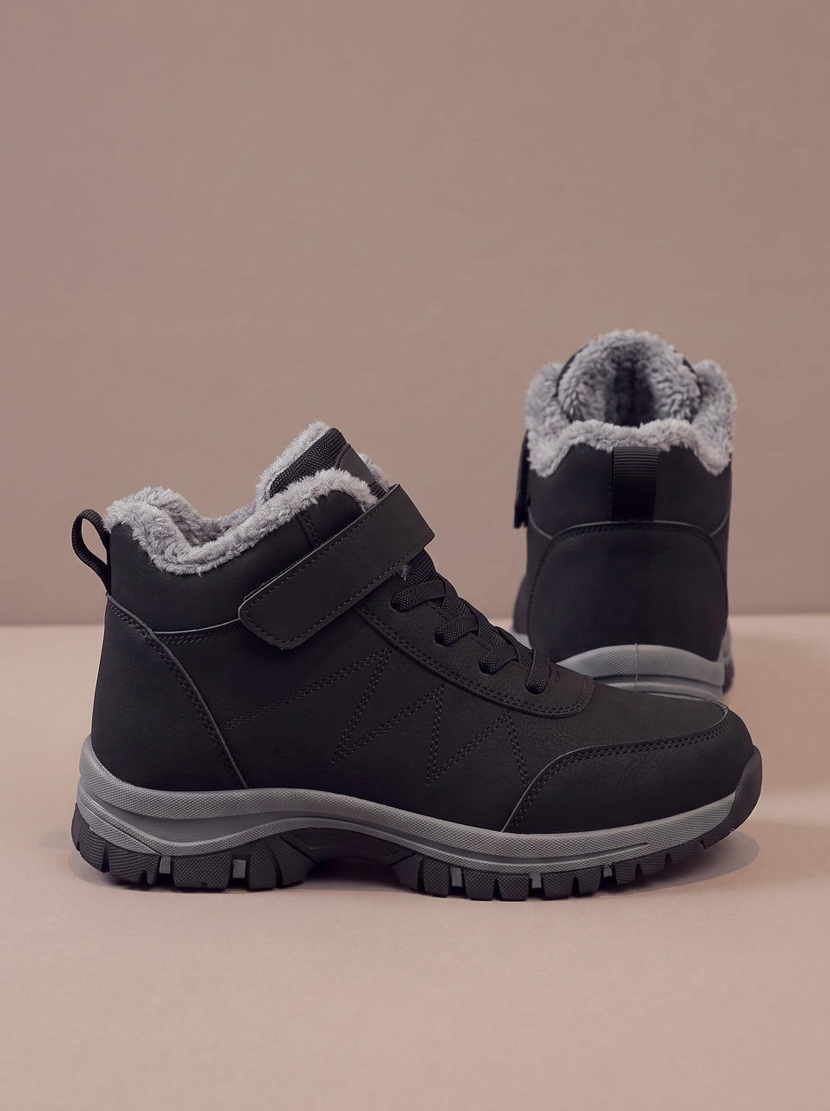 The Strap Winter Boot in black, side and back view, studio