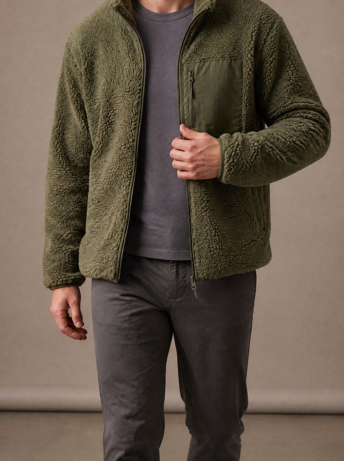 Army green teddy fleece jacket worn open over a grey T-shirt, studio view