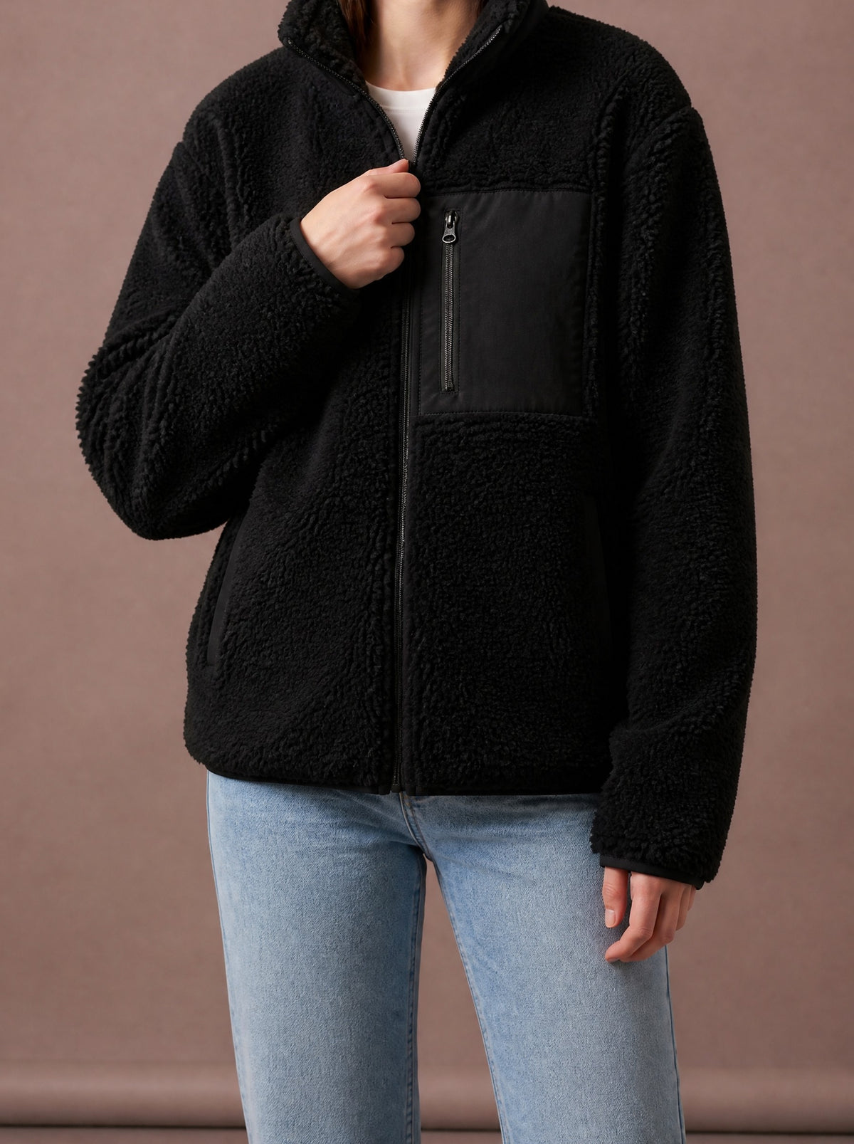 Black teddy fleece jacket for women with black woven chest pocket, studio view