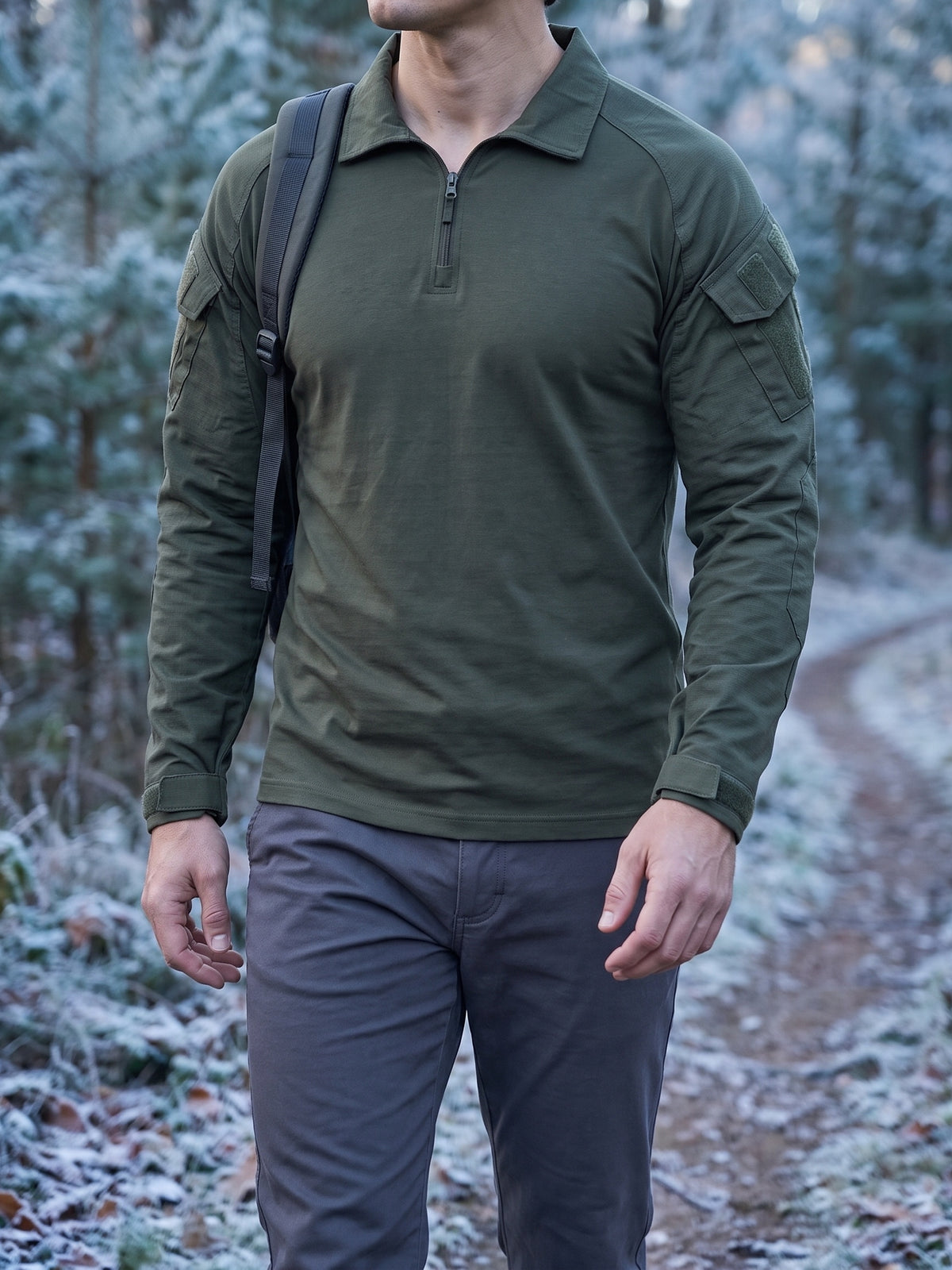 Olive combat shirt on a cold forest track with a backpack strap