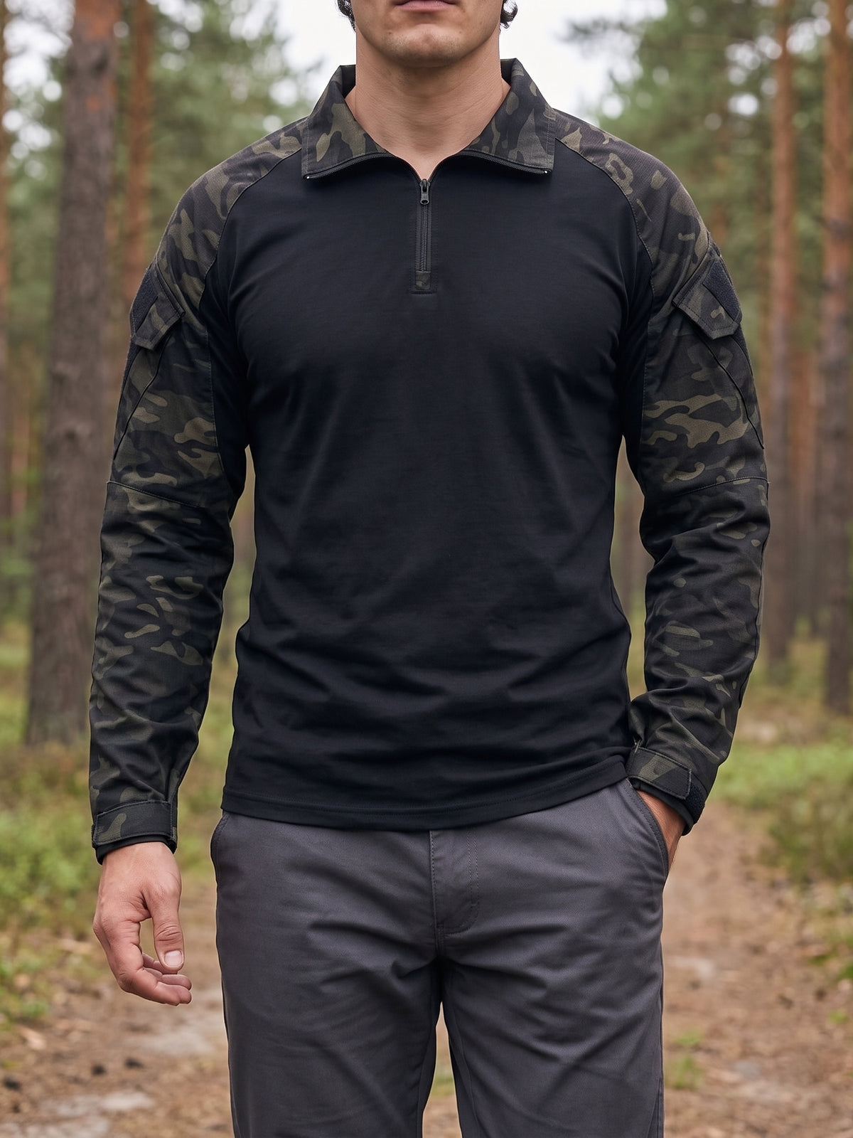 Man wearing the Combat Shirt in Black Camo on a forest track, with plain dark grey trousers