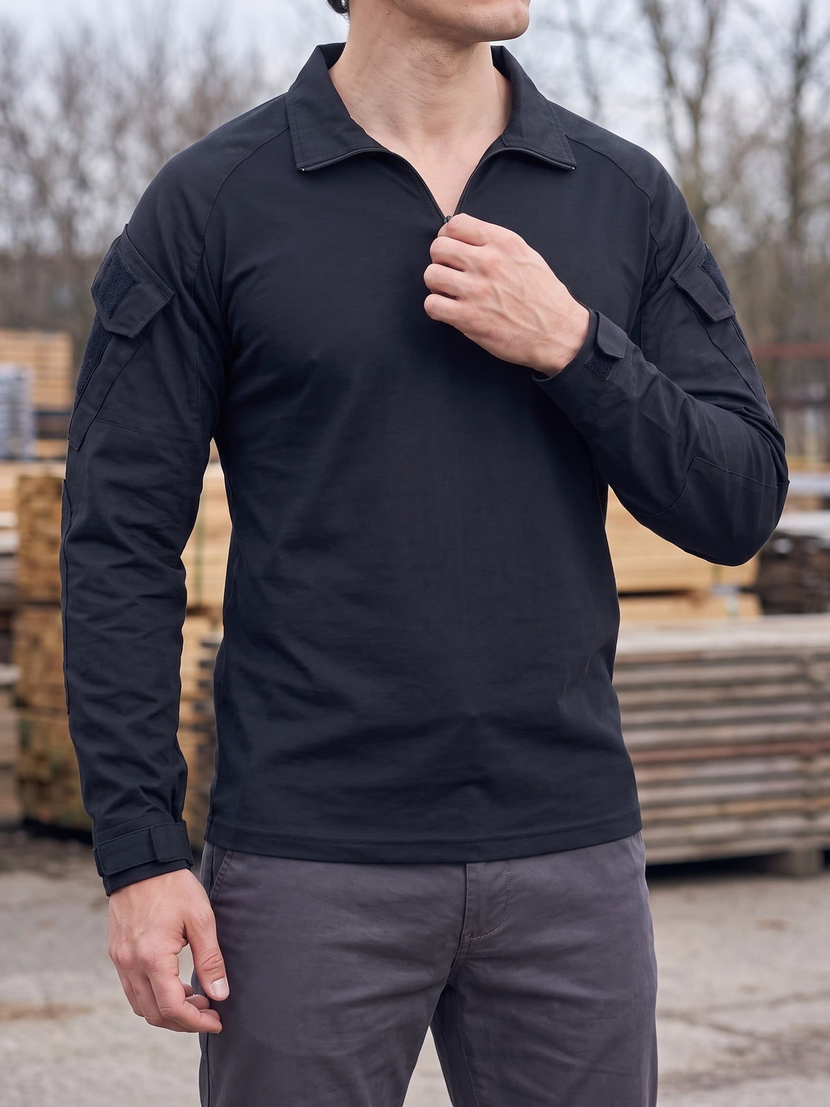 Black combat shirt outdoors with the collar zip opened