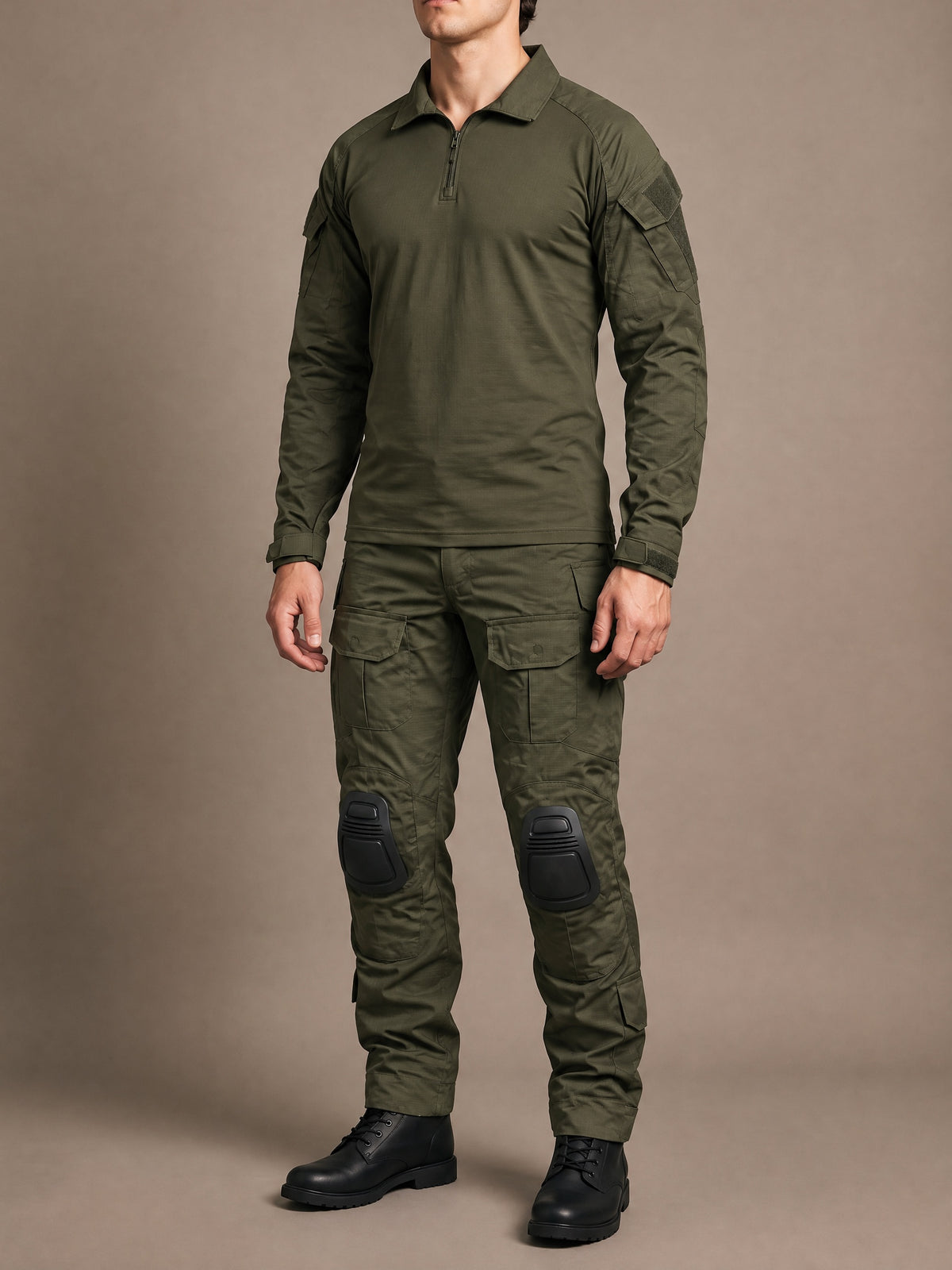 Men's Tactical Combat Set in solid olive green, olive combat shirt with quarter zip and olive combat trousers with black knee pads, worn standing relaxed