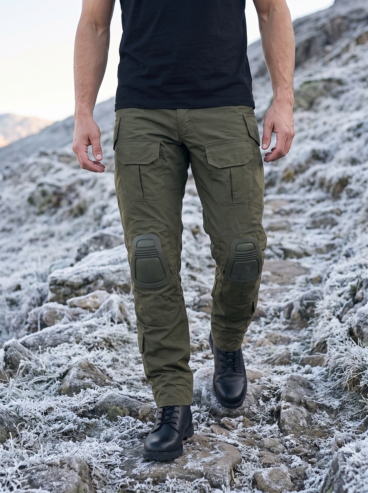 Olive combat trousers walking on a frosty rocky trail