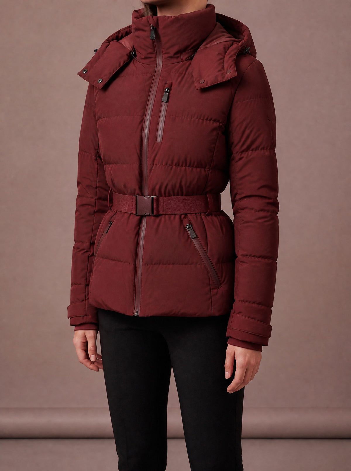 Burgundy padded winter jacket for women with hood and belted waist, studio view