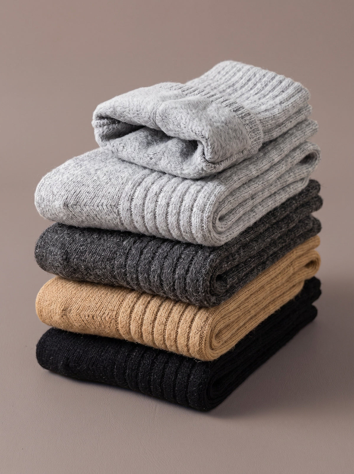 Folded pairs of The Cabin Sock in grey, deep grey, khaki and black
