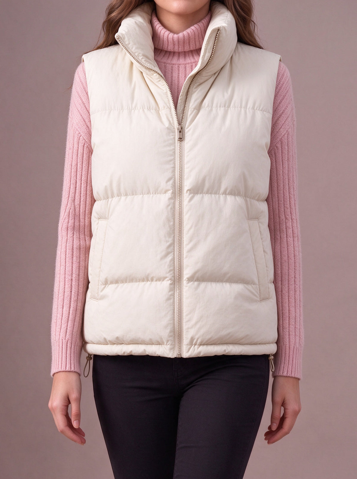 Cream quilted vest over a pink rib knit, studio view