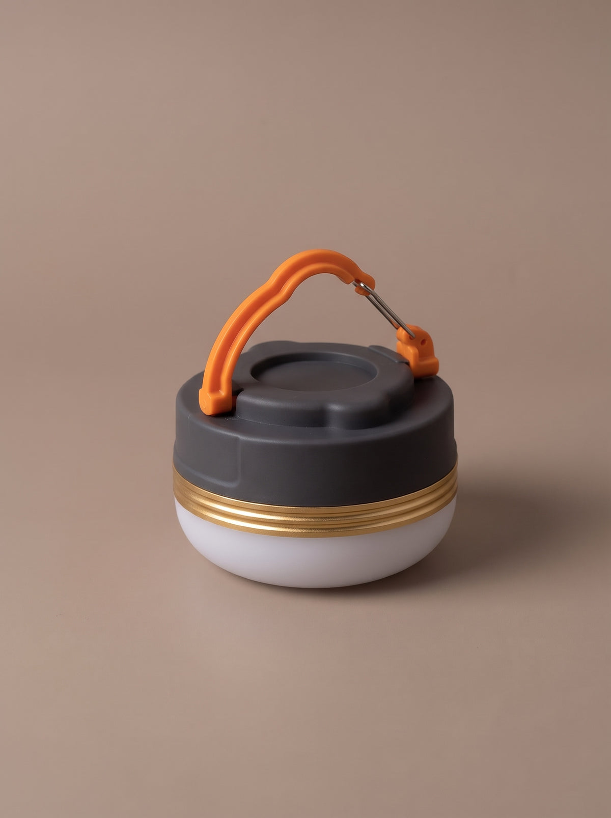The camp lantern switched off, seen from above with the orange hook handle, studio view