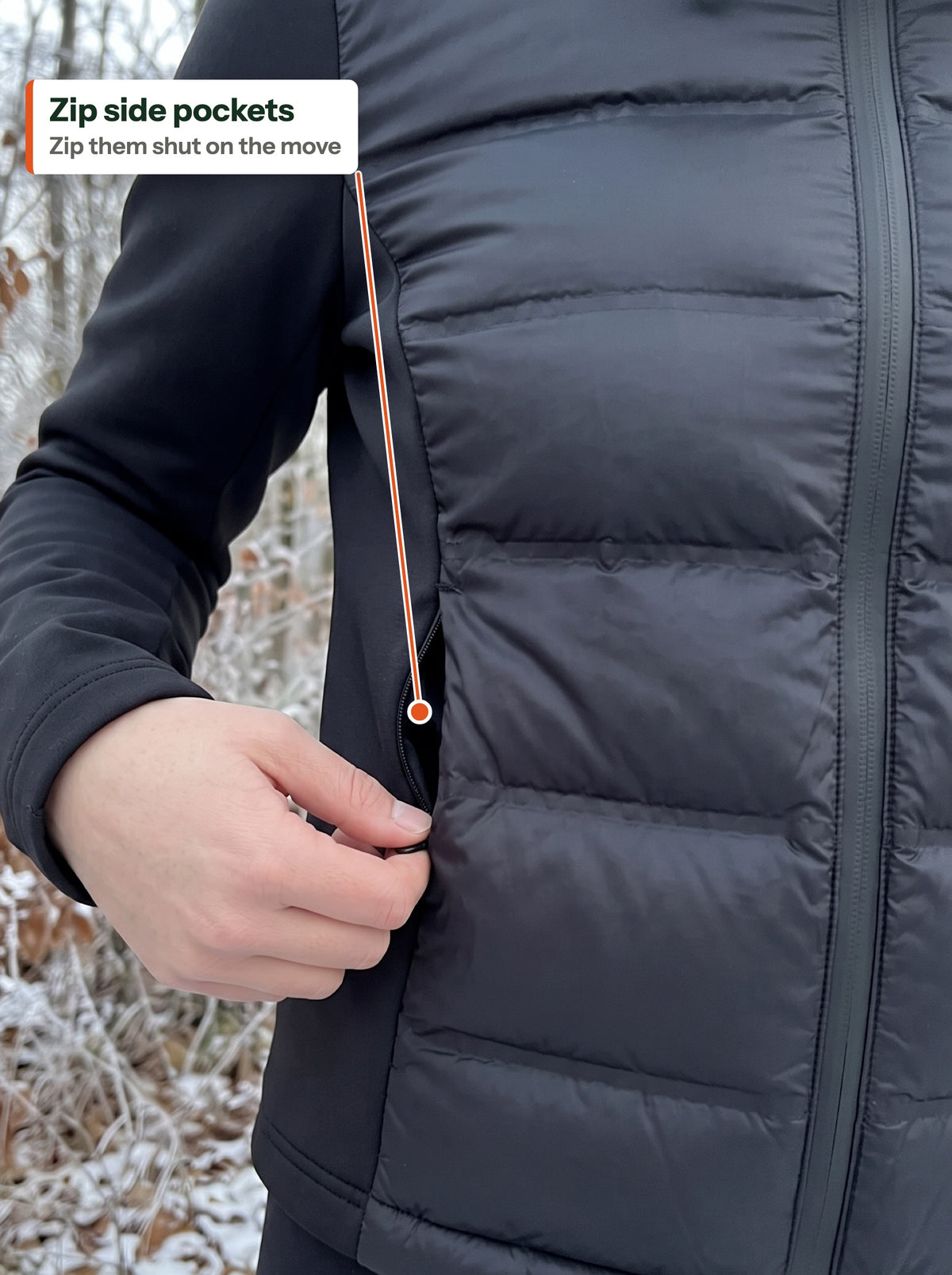 Hand opening the zip side pocket of the hybrid puffer jacket (EN label)