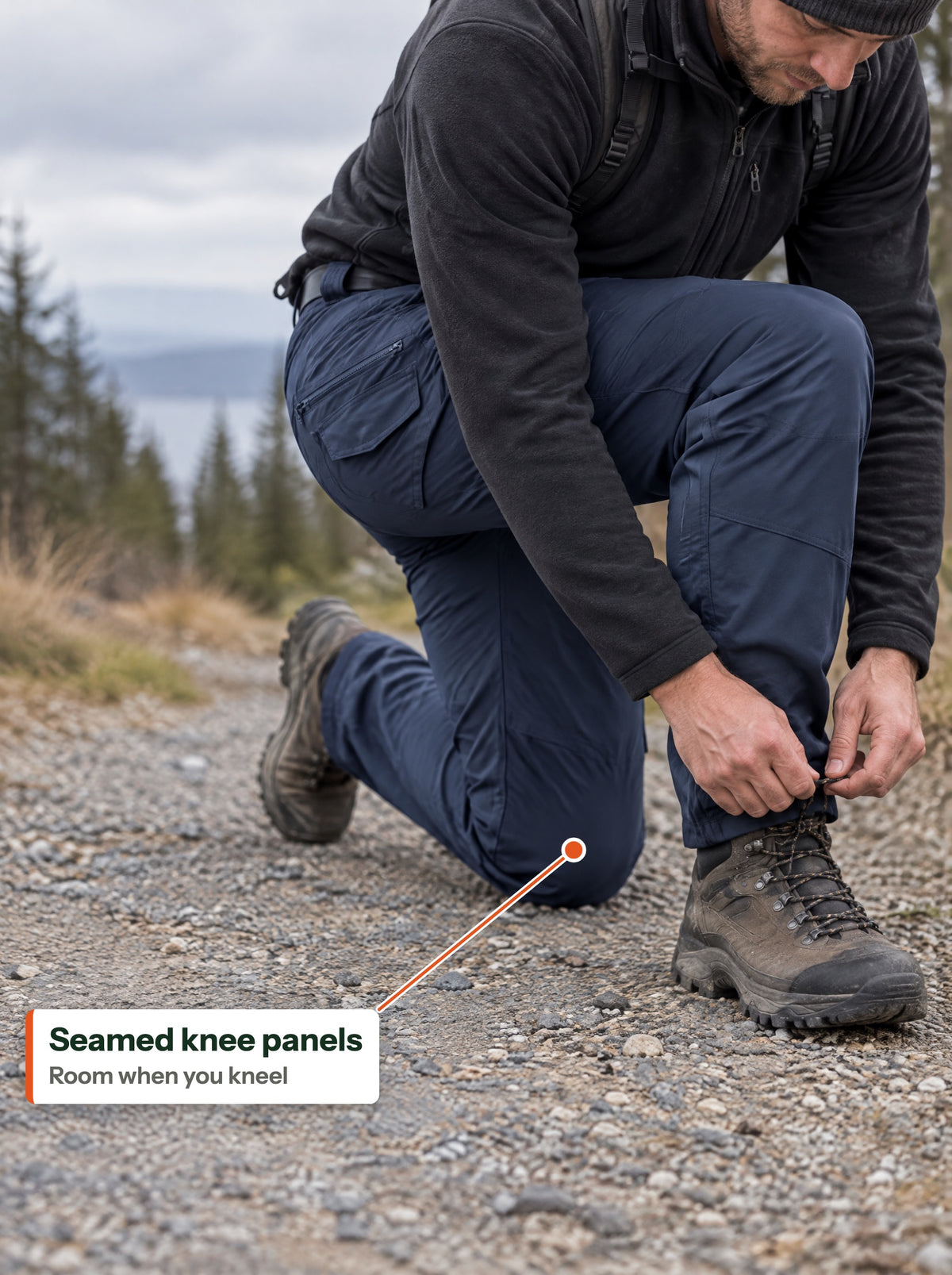 Kneeling on a gravel trail, seamed knee panels (EN label)