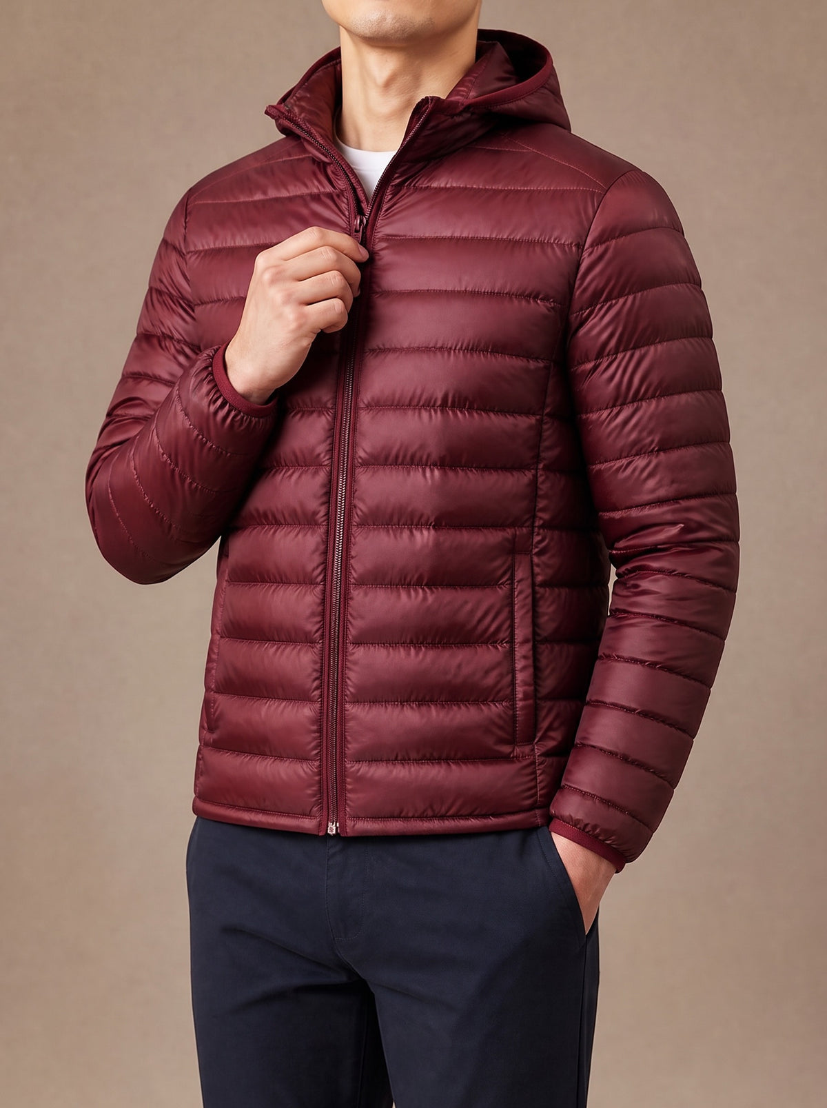 Burgundy packable down jacket zipped up, studio view