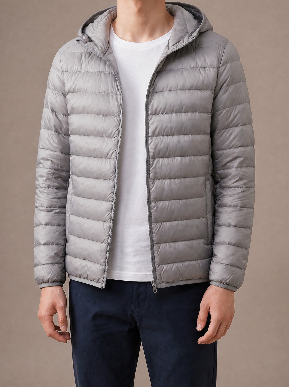 Grey hooded packable down jacket for men with narrow quilting, studio view