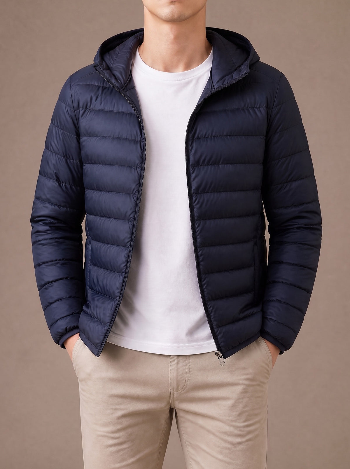 Navy hooded packable down jacket worn open over a white T-shirt, studio view