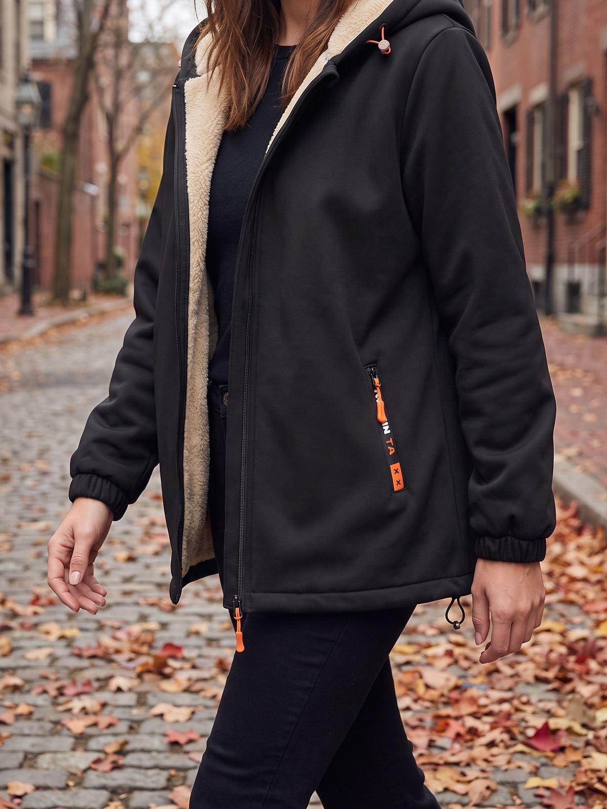Black hooded zip jacket worn open on a city street