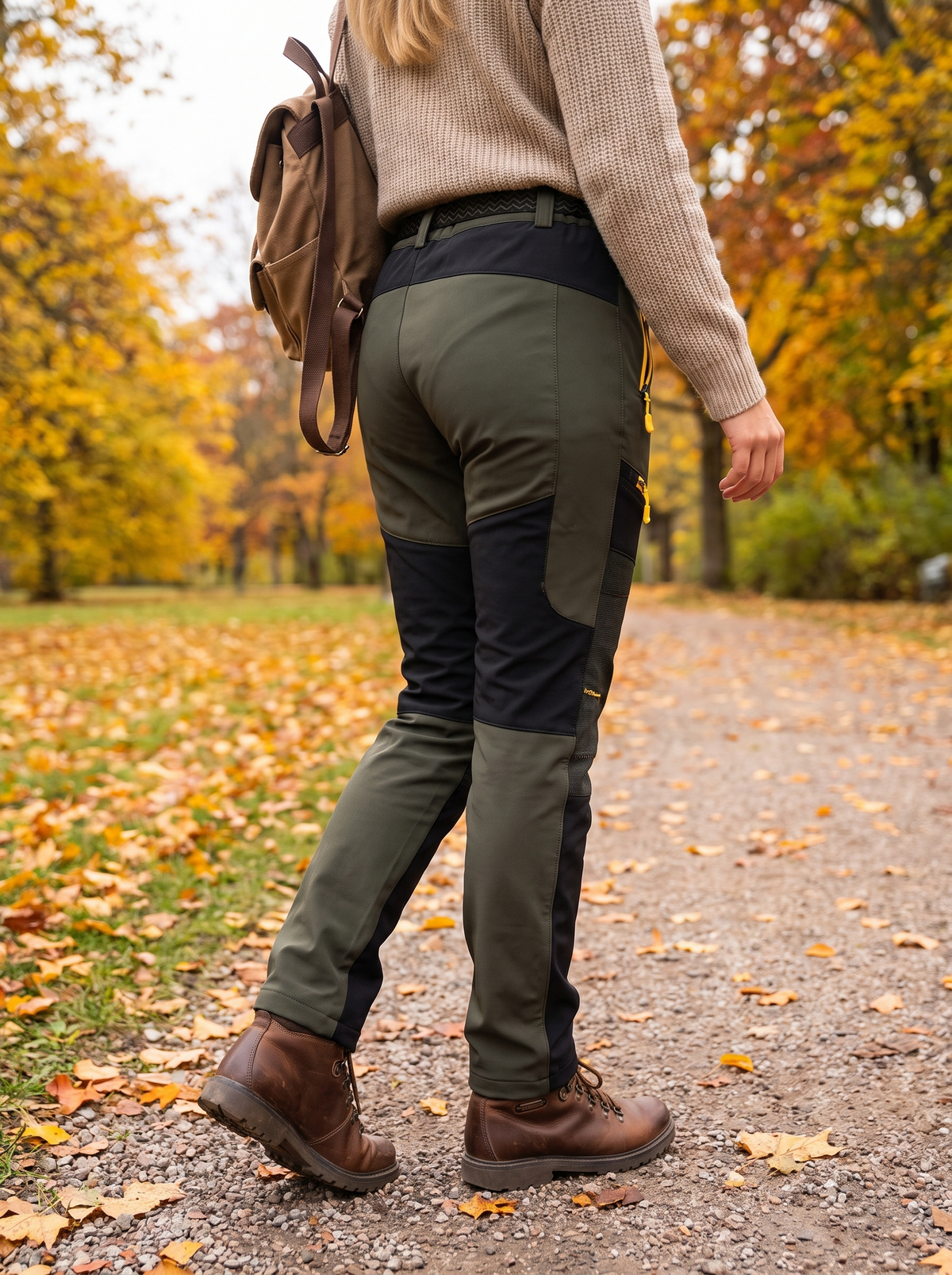 Green colour-block softshell trousers worn on an autumn park walk