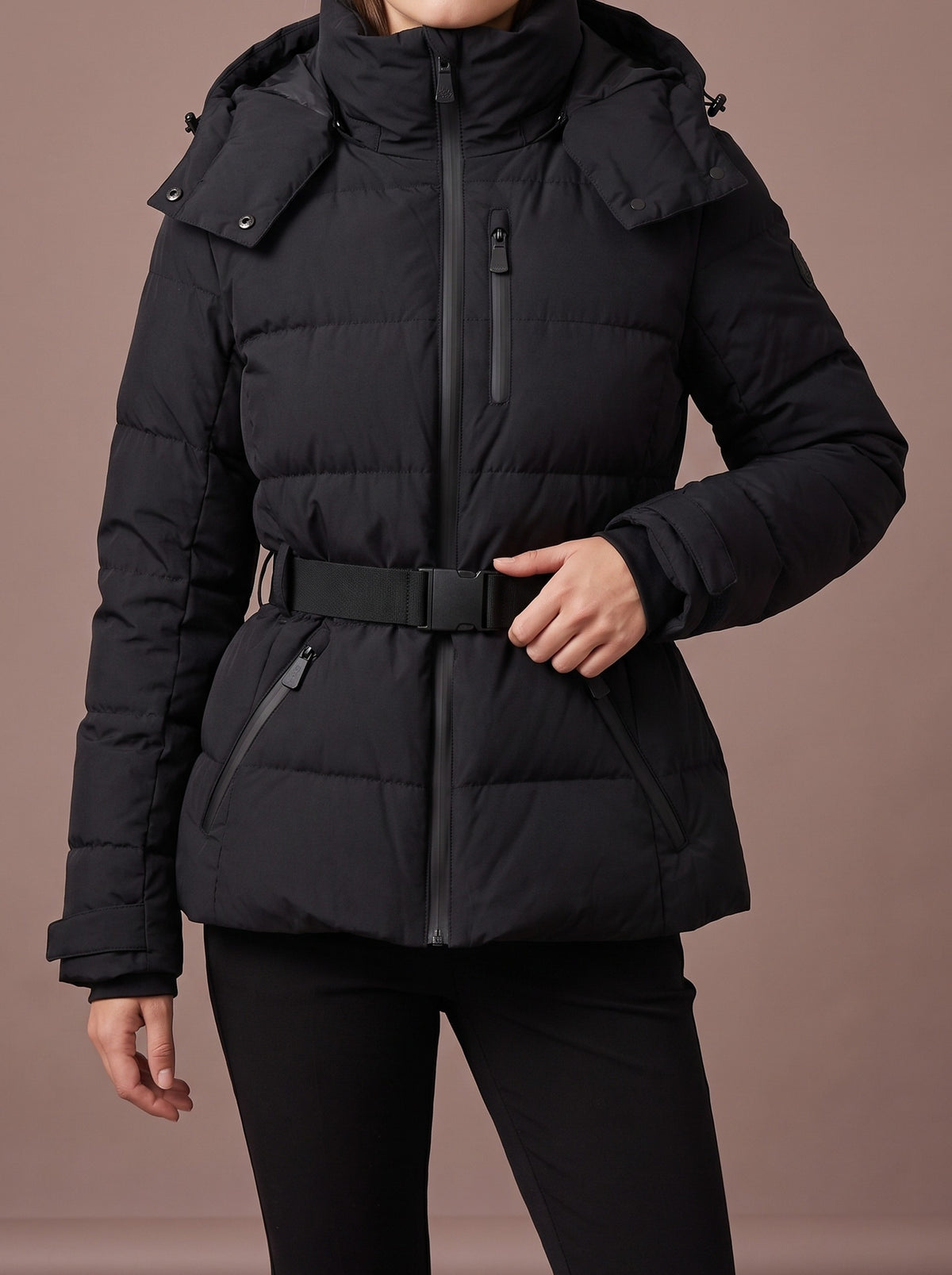 Black padded winter jacket for women with hood and belted waist, studio view