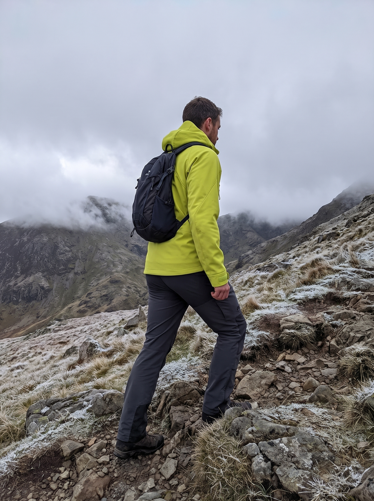 Lime softshell jacket on a frosty mountain path